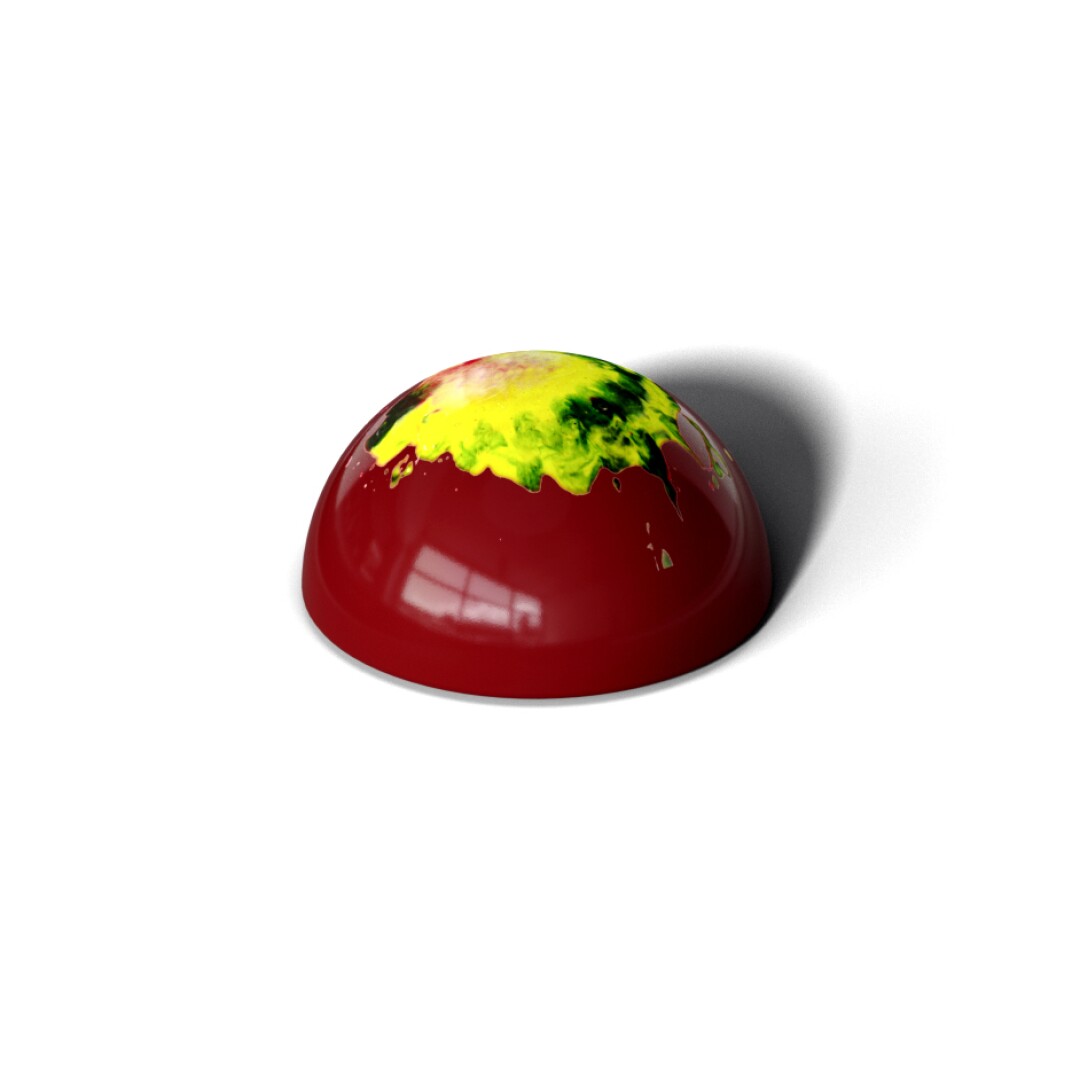 A photo of a red, dome-shaped piece of chocolate.