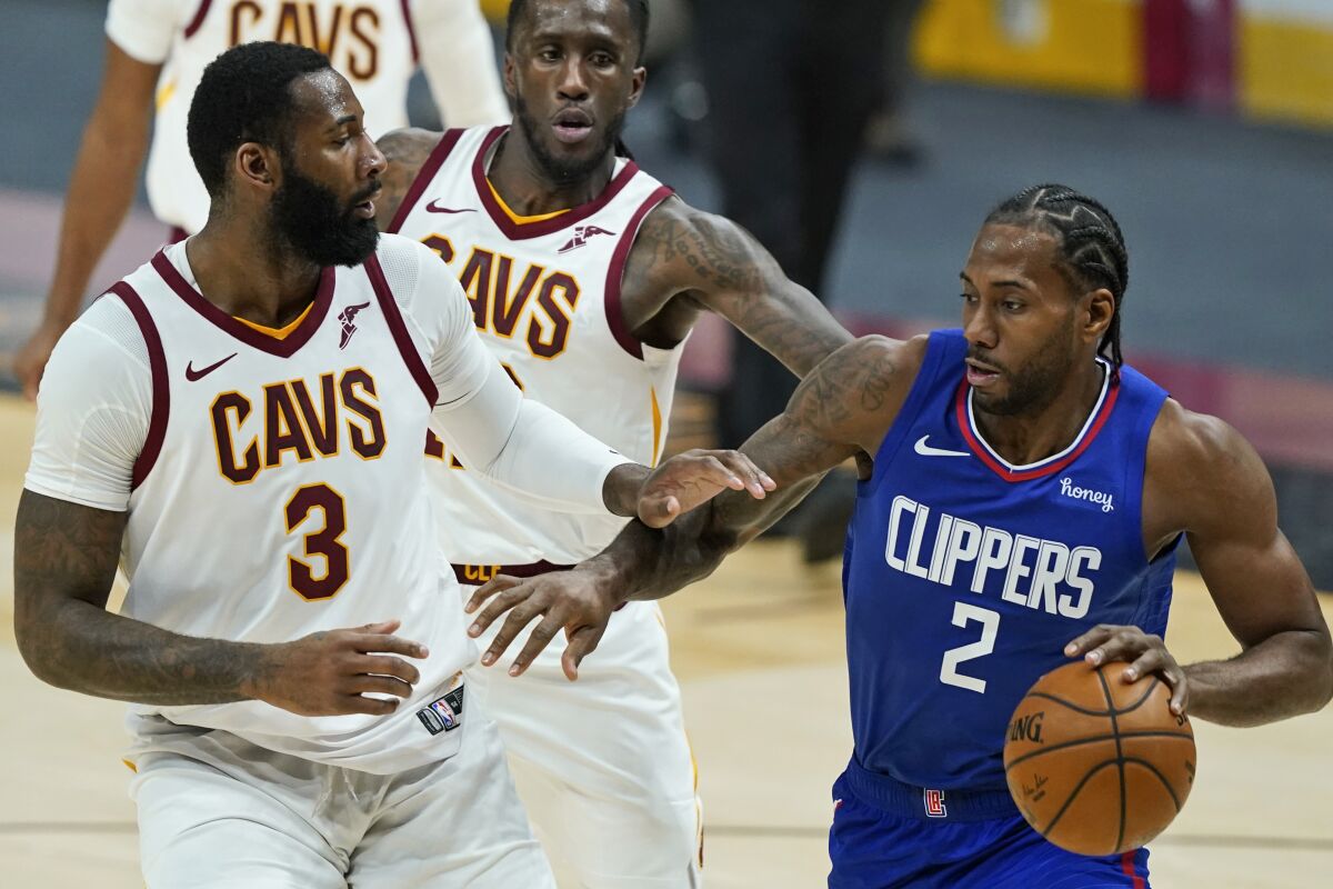 Clippers' Kawhi Leonard drives against Cleveland Cavaliers' Andre Drummond.