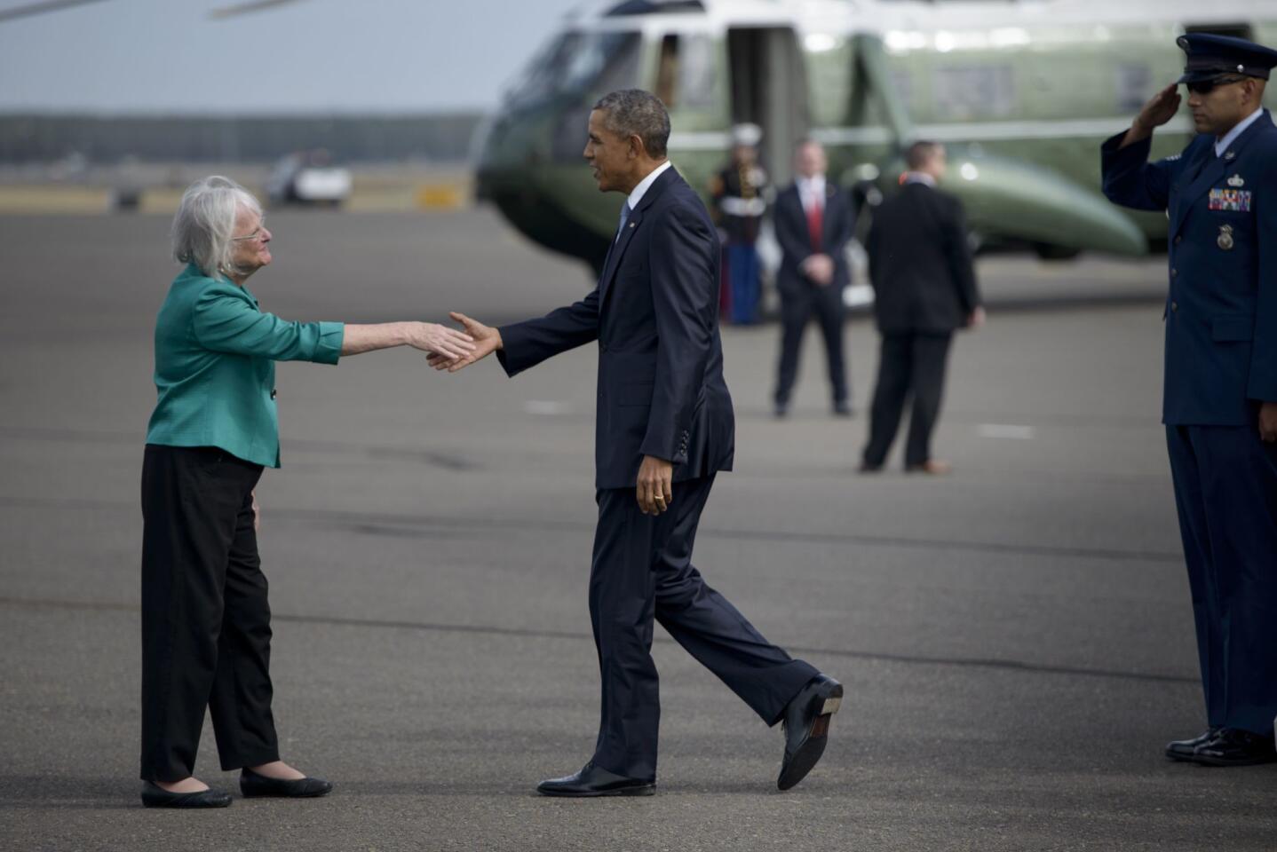 US President Barack Obama is greeted by Eugene Mayor Kitty Piercy at Eugene Airport October 9, 2015.