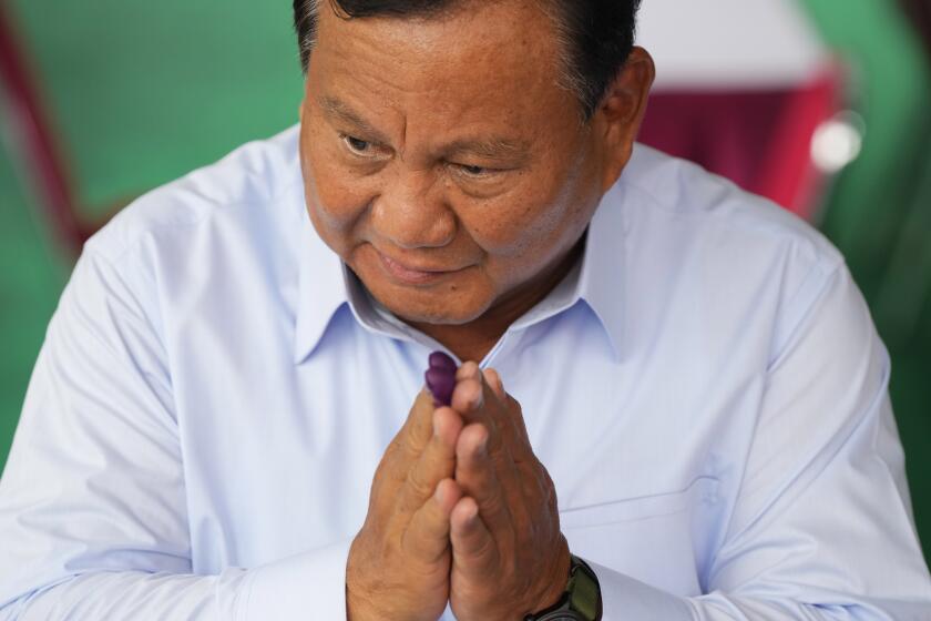 Indonesian presidential candidate Prabowo Subianto gestures after casting his vote during the election in Bojong Koneng, Indonesia, Wednesday, Feb. 14, 2024. Indonesian voters were choosing a new president Wednesday as the world's third-largest democracy aspires to become a global economic powerhouse a quarter-century after shaking off a brutal dictatorship. (AP Photo/Vincent Thian)