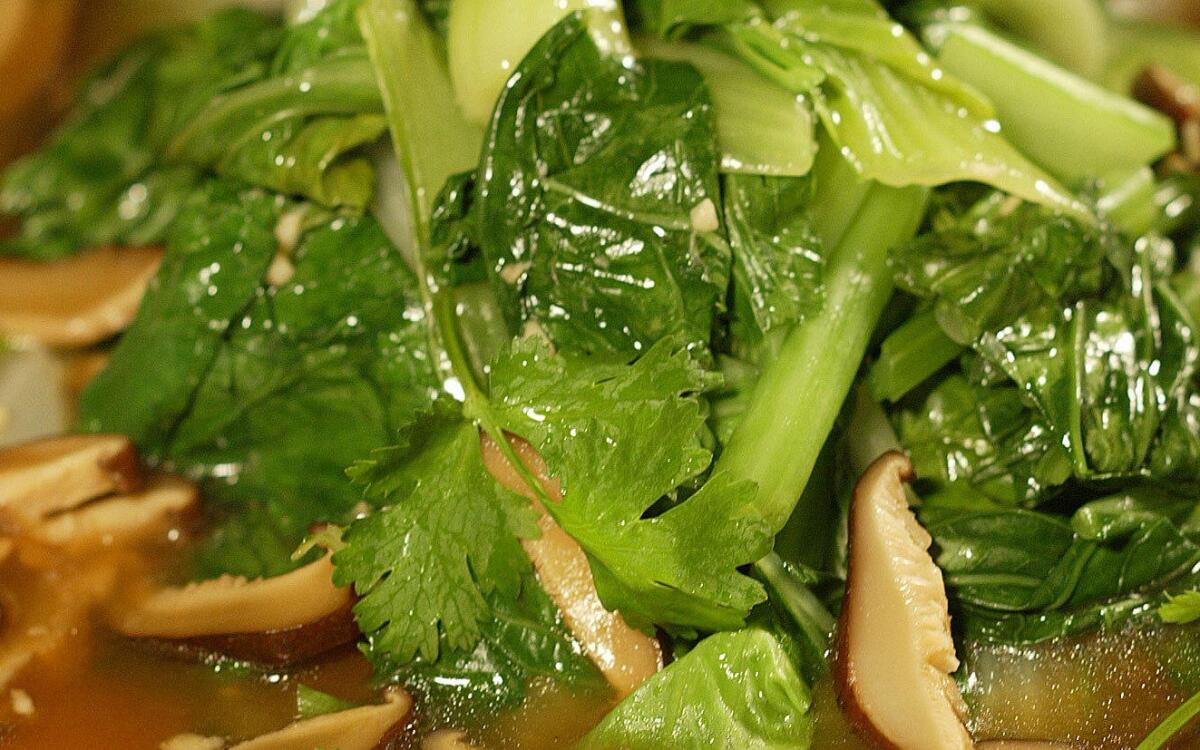 Steamed leafy greens with mushroom sauce