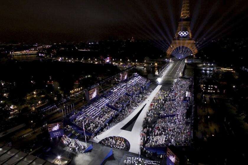 This photo released by the Olympic Broadcasting Services shows the Trocadero and the Eiffel Tower lightened up with the Olympic Rings during the opening ceremony for the 2024 Summer Olympics in Paris, France, Friday, July 26, 2024. (Olympic Broadcasting Services via AP)