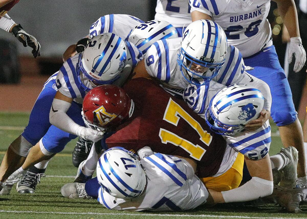 Arcadia's Chris Wilson is stopped and tackled by nearly half of the Burbank defense in a Pacific League football opener at Arcadia High School on Thursday, September 19, 2019.