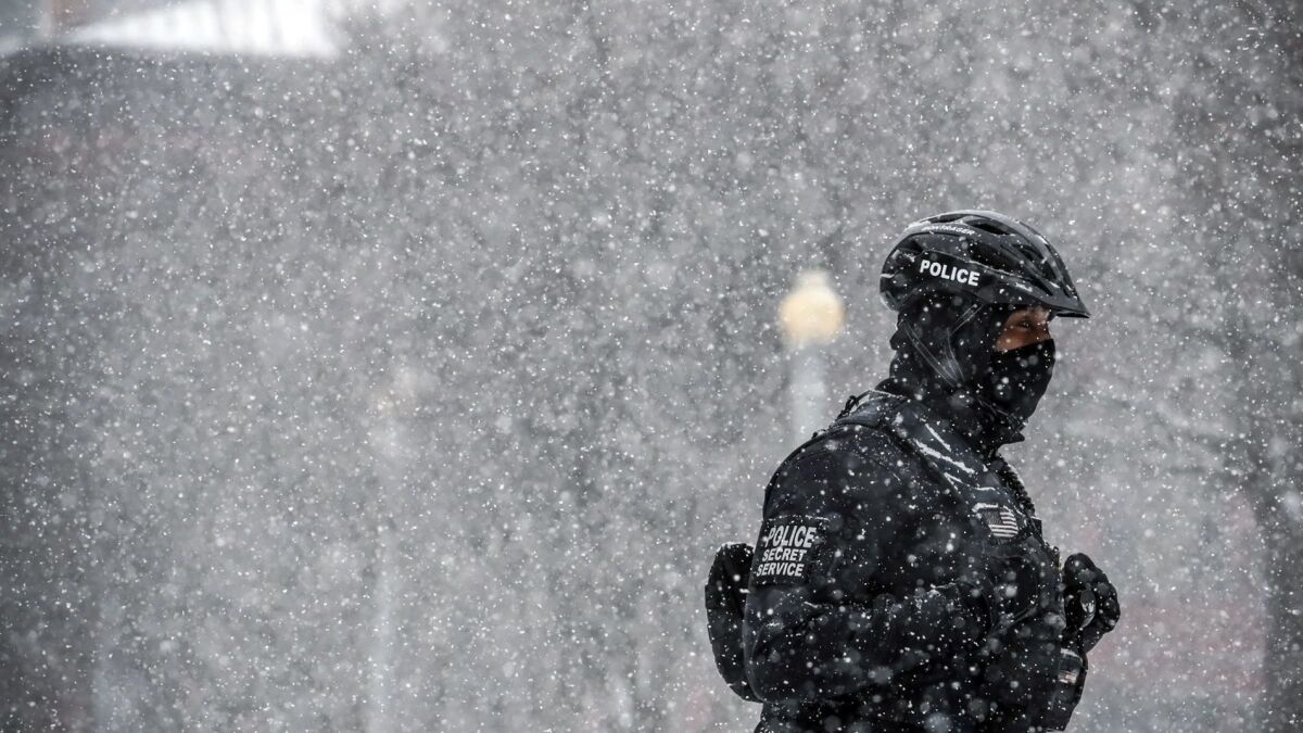 A Secret Service officer guards the White House during a Washington snowstorm Friday.