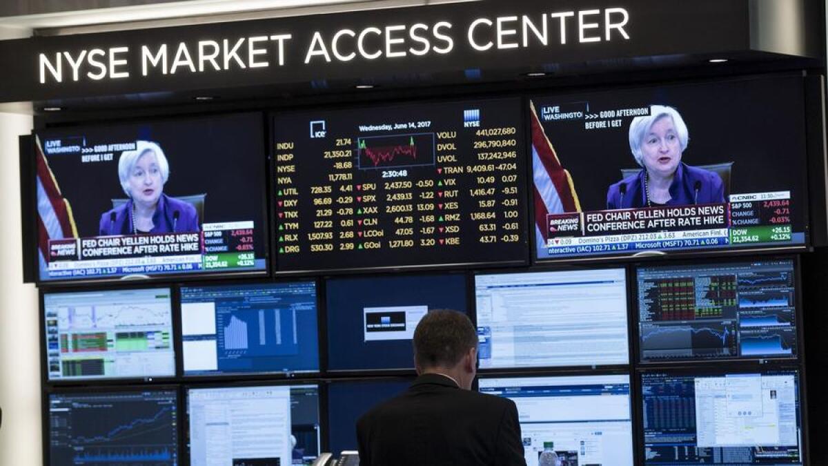 TV monitors on the floor of the New York Stock Exchange show Federal Reserve Chairwoman Janet L. Yellen.