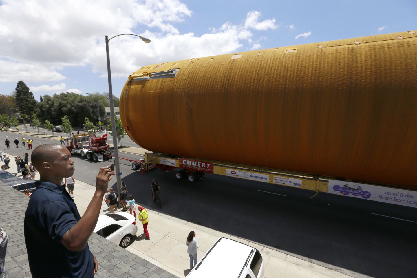 Bashaun Nero of Inglewood stands on a roof in Inglewood as the space shuttle fuel tank ET-94 gets ready for its final journey home.