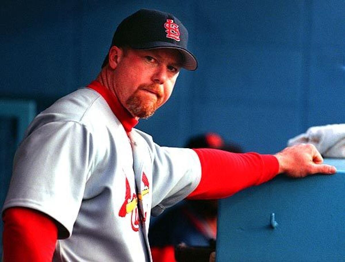 Cardinals first baseman Mark McGwire looks out from the dugout before a game at Dodgers Stadium on Apr. 23, 1999.