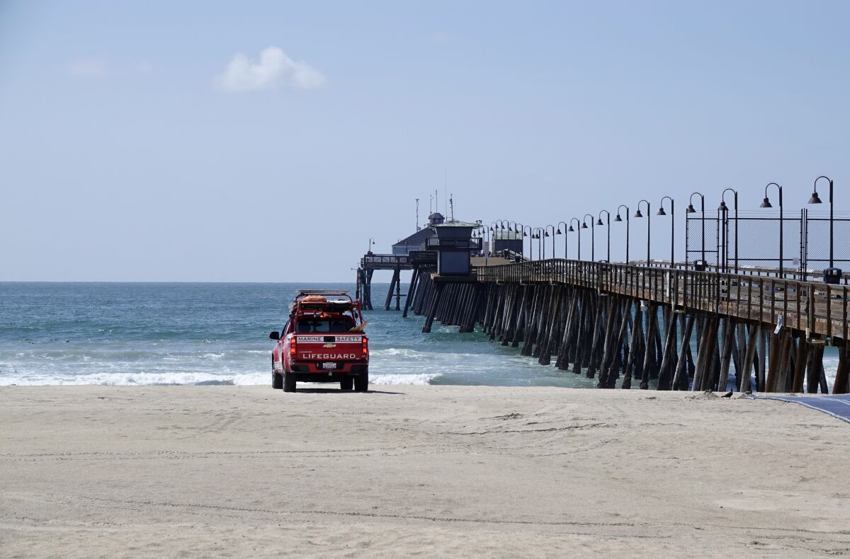 March 2020 file photo: Imperial Beach lifeguard patrols beach and pier, closed to the public due to the coronavirus pandemic.