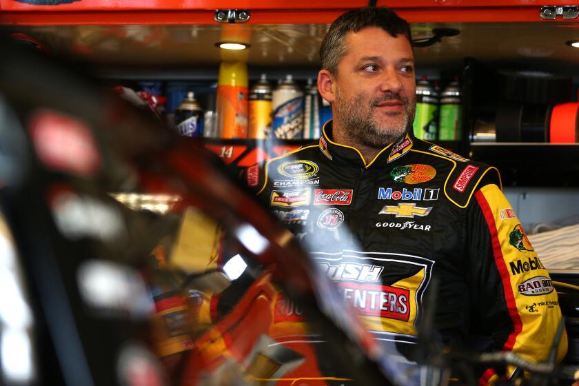 NASCAR driver Tony Stewart looks on from a garage during a practice for a Sprint Cup series race on July 10.