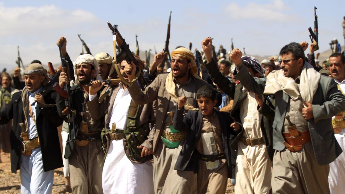 Armed Yemeni men raise their weapons as they gather Feb. 21 near the capital, Sana, to show their support to the Shiite Houthi movement against the Saudi-led intervention.