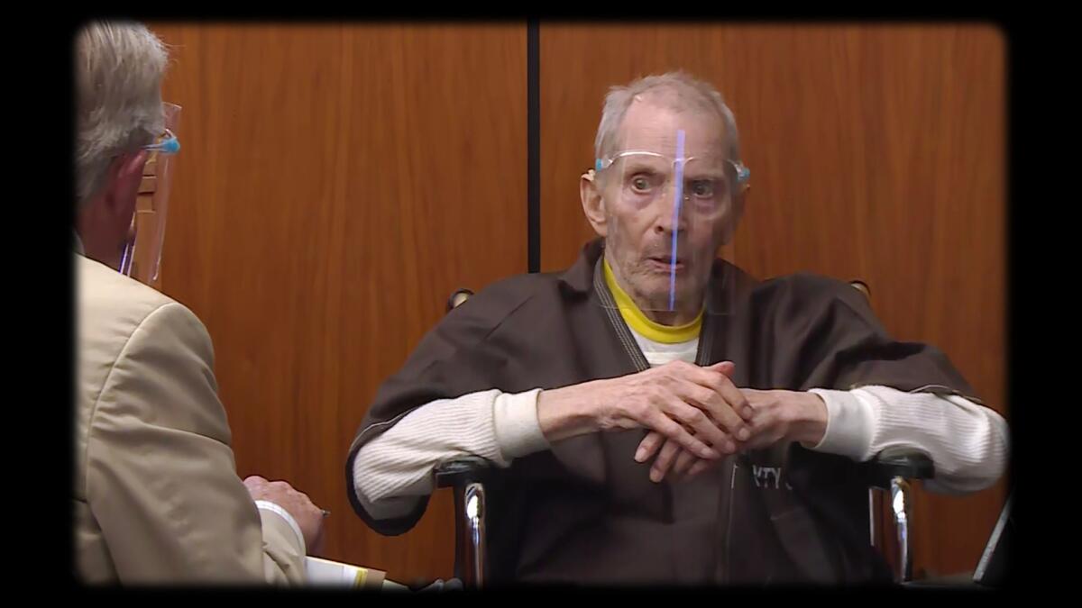 Robert Durst wearing a face shield and sitting in a courtroom.
