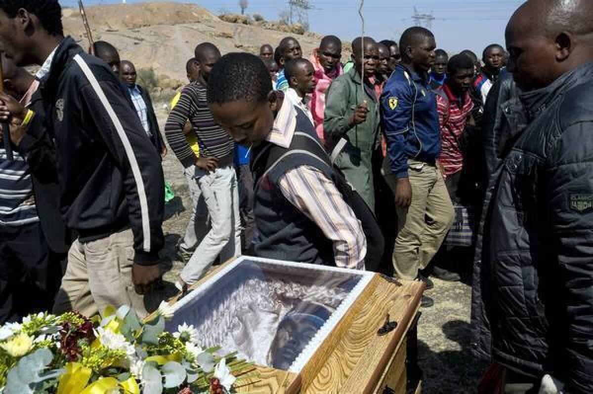 Miners attend a funeral for strikers killed by police on Aug. 16 at the Lonmin company platinum mine in Marikana, South Africa.