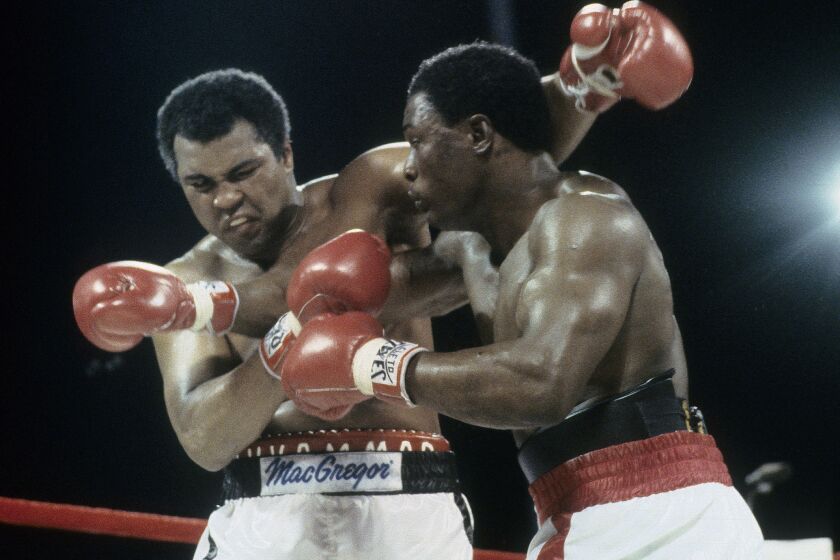 Trevor Berbick, right, throws a punch at Muhammad Ali on Dec. 11, 1981, at Queen Elizabeth Sports Centre in Nassau, Bahamas.