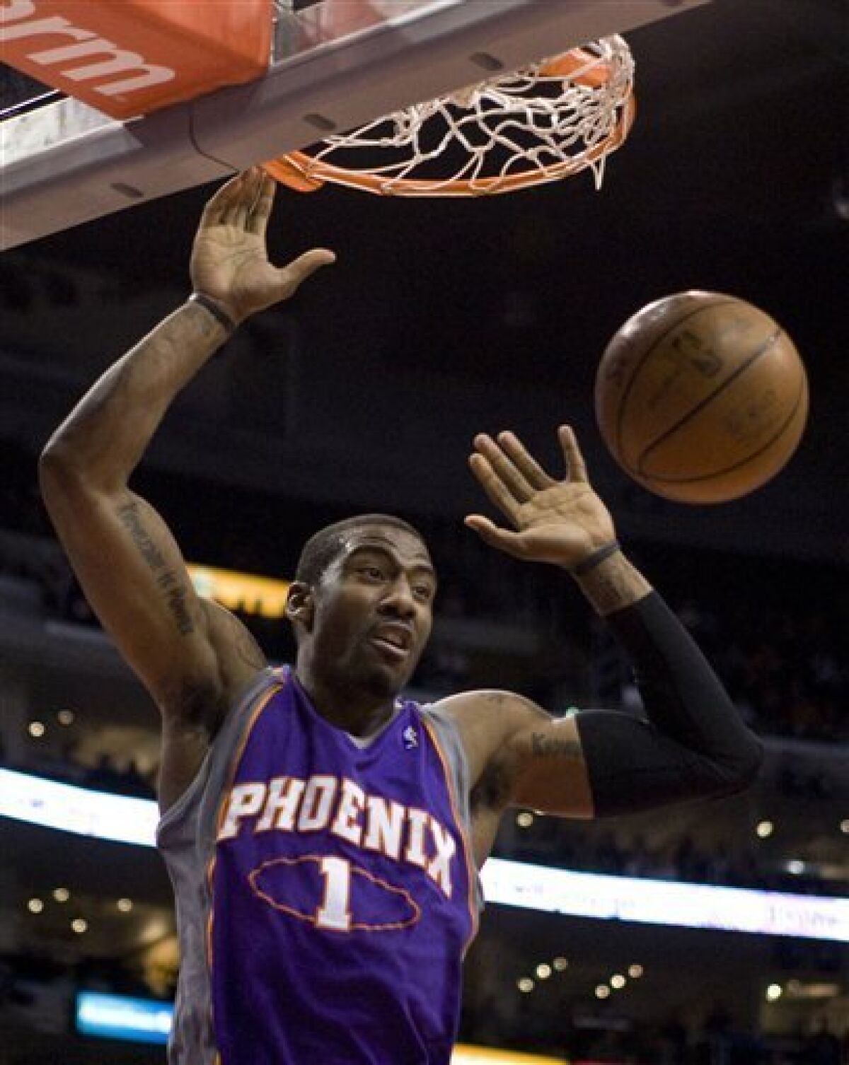 This Feb. 18, 2009 file photo shows Phoenix Suns' Amare Stoudemire scoring against the Los Angeles Clippers during the first quarter of an NBA basketball game in Los Angeles. The Phoenix Suns say Stoudemire will be out about eight weeks after eye surgery. The surgery to repair a partially detached retina in Stoudemire's right eye was performed Friday morning Feb. 20. (AP Photo/Hector Mata, File)