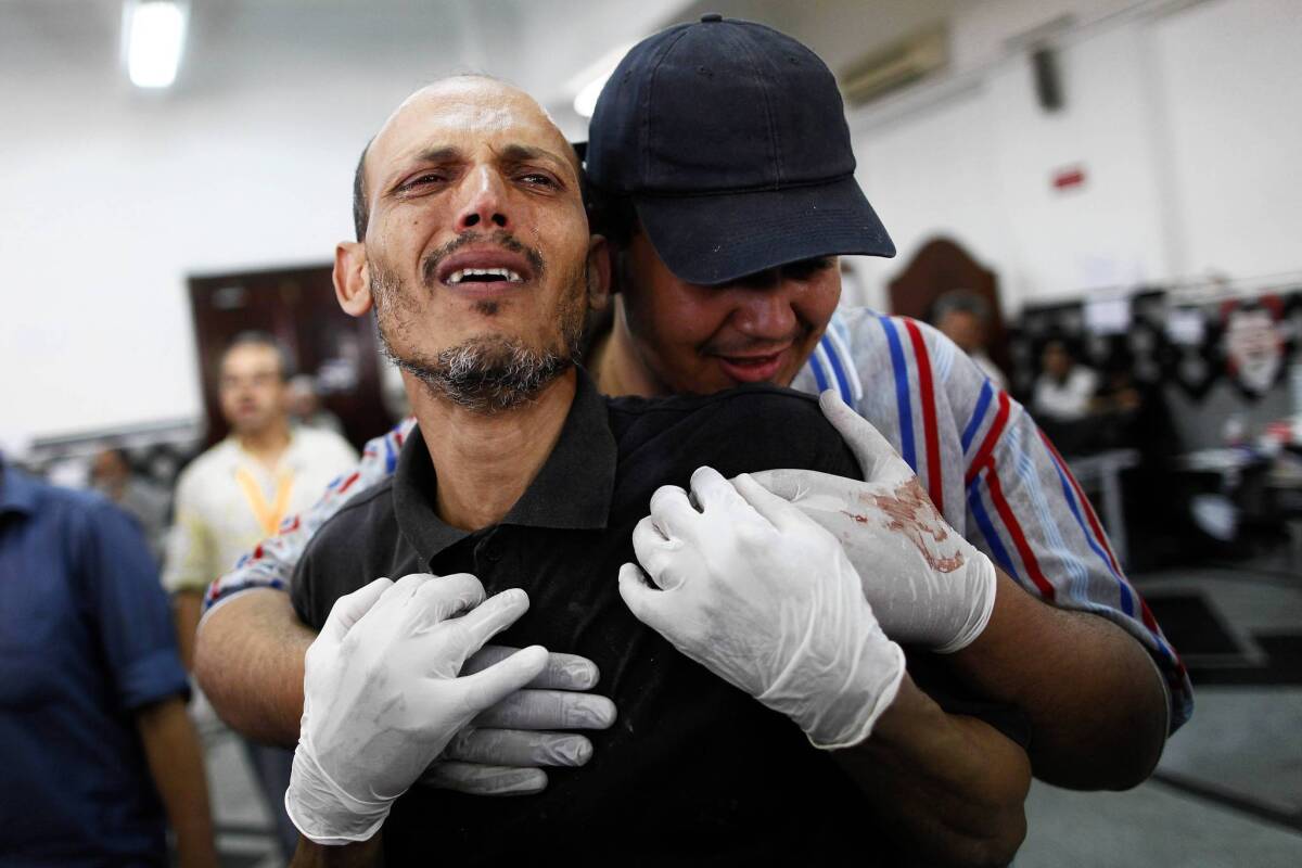 A man grieves at a makeshift hospital in Cairo after the Egyptian military's deadly crackdown on a sit-in by supporters of deposed President Mohamed Morsi.