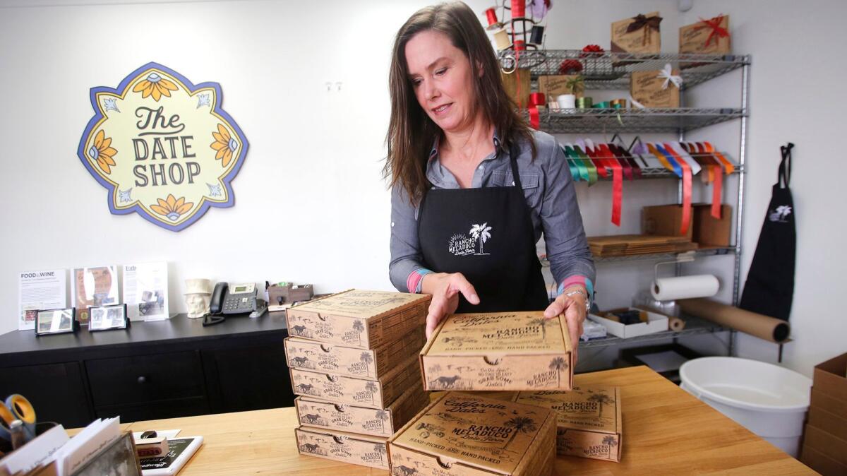 Joan Smith, founder and farmer of the Rancho Meladuco date farm, stacks online orders in her Newport Beach store.
