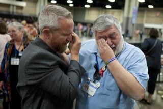 David Oliver, left, and David Meredith wipe away tears after an approval vote at the United Methodist Church General Conference Wednesday, May 1, 2024, in Charlotte, N.C. United Methodist delegates repealed their church’s longstanding ban on LGBTQ clergy with no debate on Wednesday, removing a rule forbidding “self-avowed practicing homosexuals” from being ordained or appointed as ministers. (AP Photo/Chris Carlson)