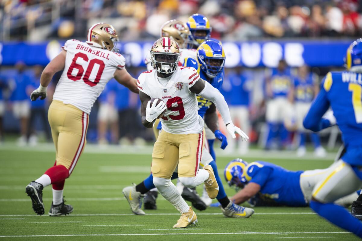San Francisco 49ers wide receiver Deebo Samuel runs with the ball during a win over the Rams on Jan. 9.