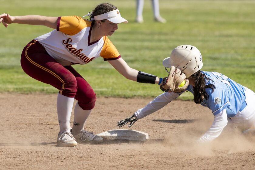 Huntington Beach, CA - May 11: Ocean View's Ashley Capelouto tags Irvine's Reese Villanueva on a stole base attempt during a CIF Southern Section Division 5 quarterfinal game on Thursday, May 11, 2023 in Huntington Beach, CA. Villanueva was called safe on the play. (Scott Smeltzer / Daily Pilot)