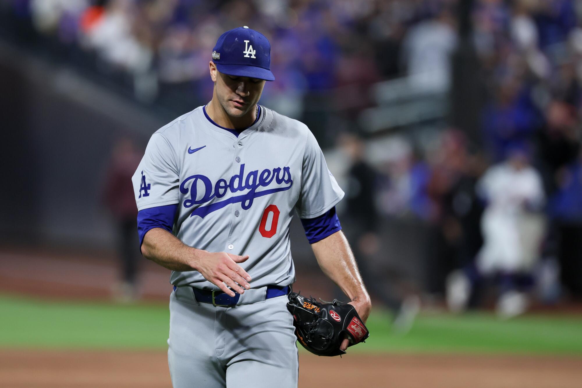 Dodgers starting pitcher Jack Flaherty walks off the field after giving up five runs in the third inning.