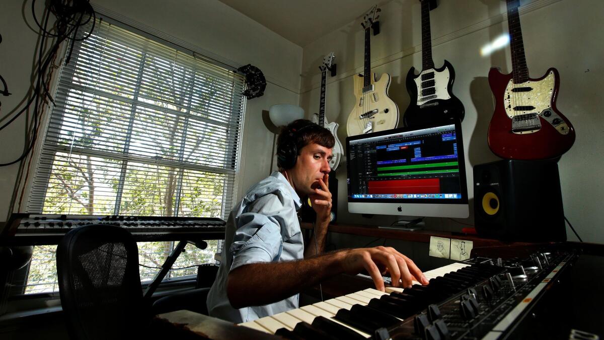 Composer and musician Nick Thorburn plays a synthesizer inside his home studio in Los Angeles.