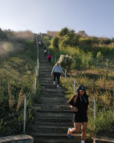 People taking in their morning exercise and views at the Culver City Stairs at Baldwin Hills Scenic Overlook