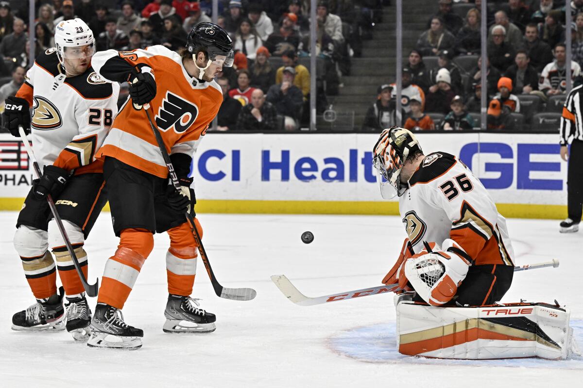 Ducks goalie John Gibson blocks a shot with Philadelphia Flyers left wing Joel Farabee.