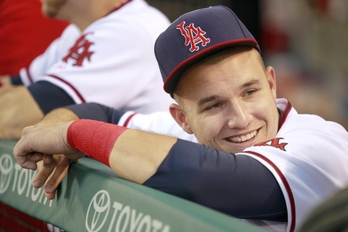 Mike Trout laughs with an Angels teammate in the dugout. The 22-year-old center fielder played in his second Major League All-Star Game in 2013.