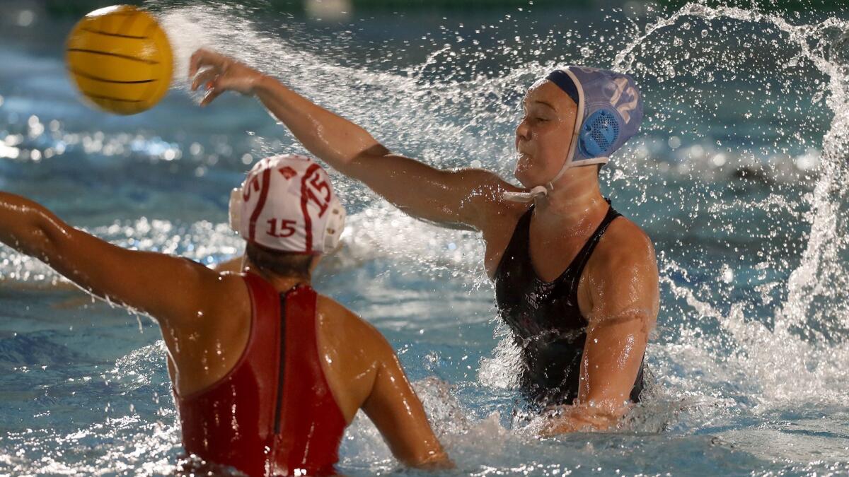 Sophie Wallace, seen shooting the ball against Orange Lutheran High on Dec. 11, is a key player for the Corona del Mar girls' water polo team.