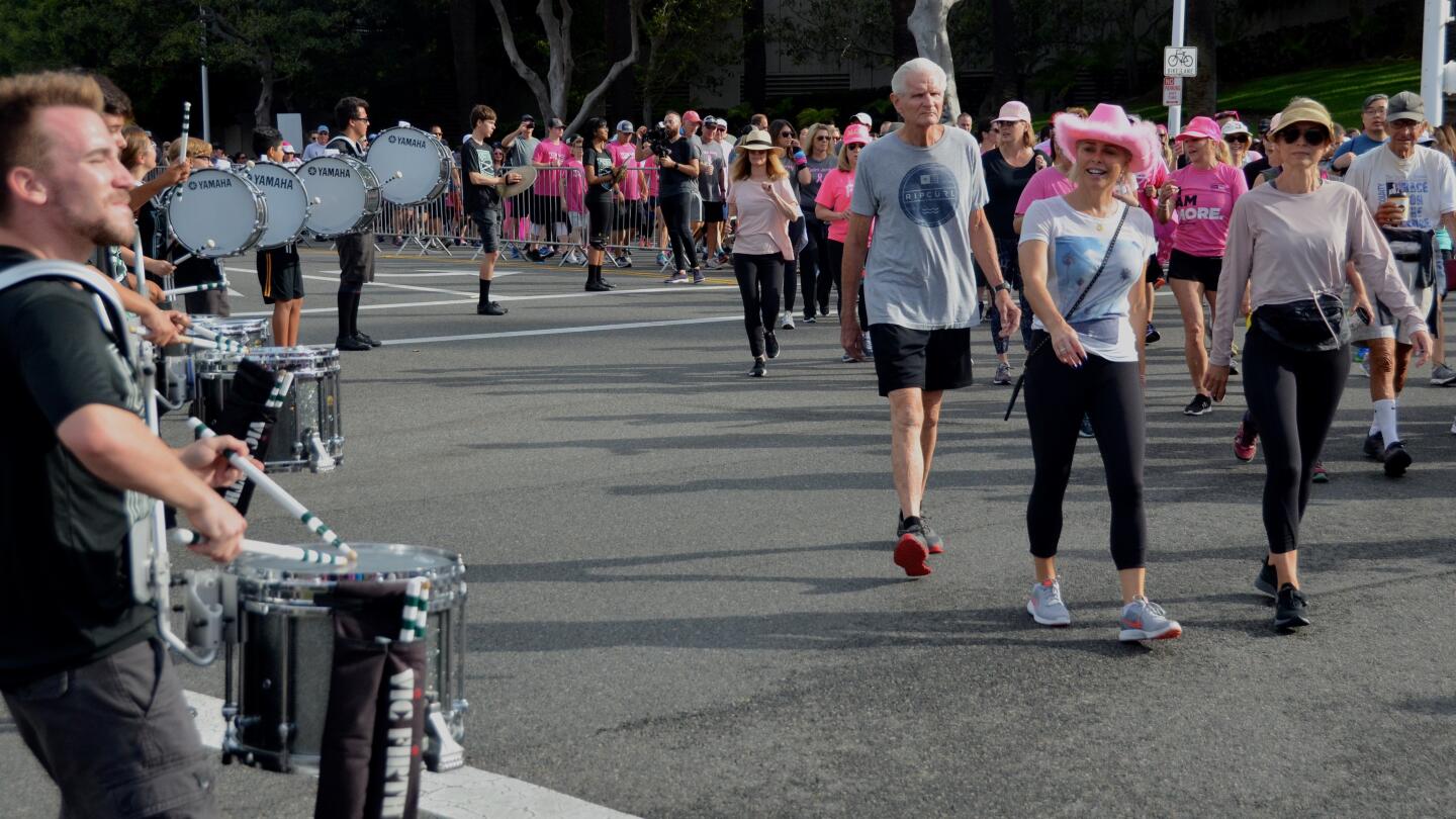 The Costa Mesa High School drum line plays for walkers during the More than Pink 5K on Sunday in Newport Beach.
