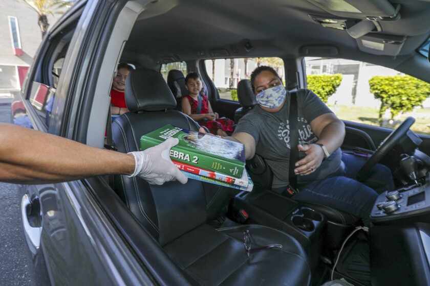Alana Respicio collects books for her kids at Marco Antonio Firebaugh High School in Lynwood.
