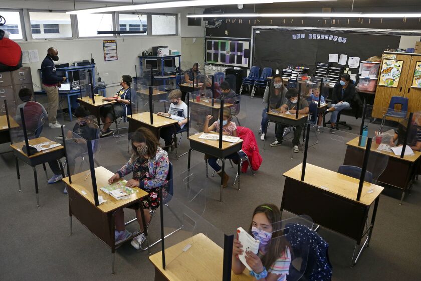 Third through fifth-grade students in Maurice Simmons classroom on Wednesday at Village View Elementary in Huntington Beach. The Ocean View School District has announced that elementary school kids will be transitioning back to five days a week on-campus instruction through April 19.