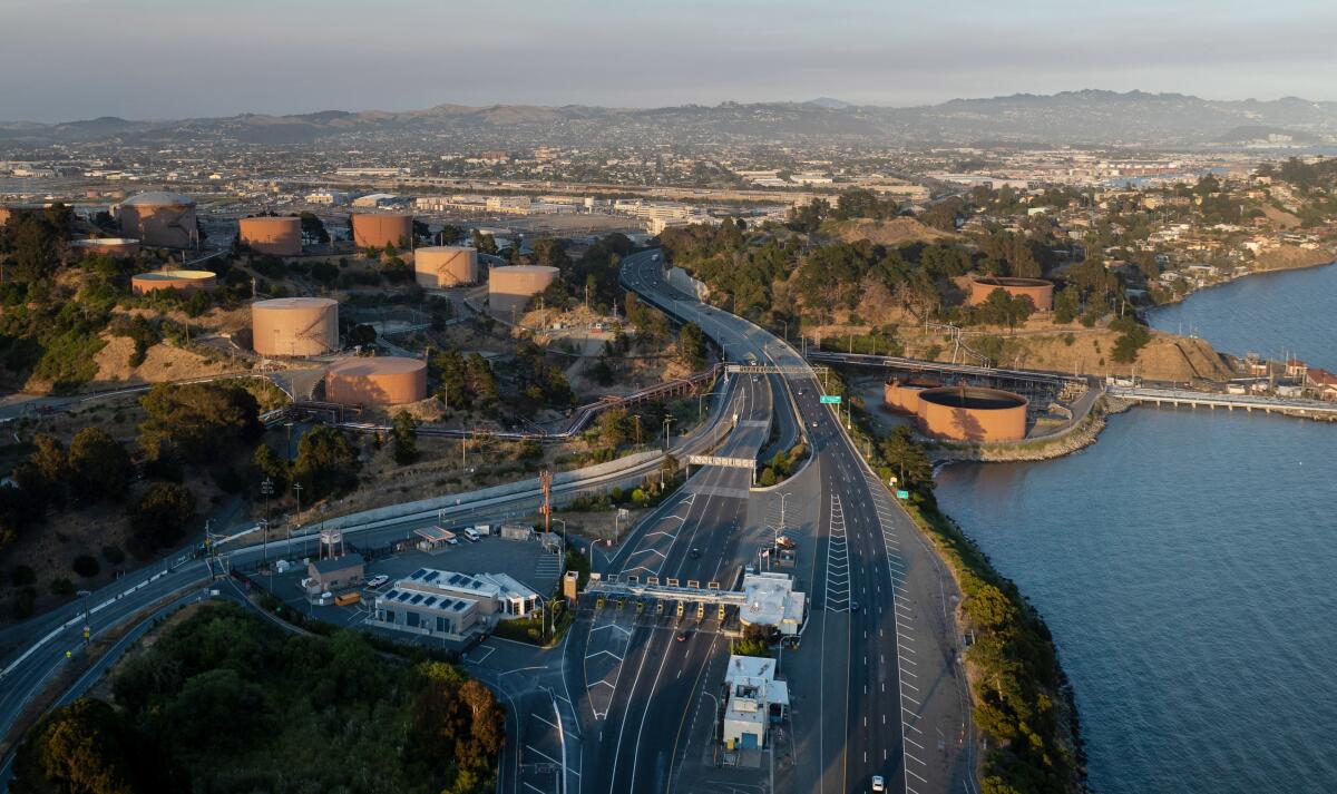 An aerial view of storage tanks at a coastal site.