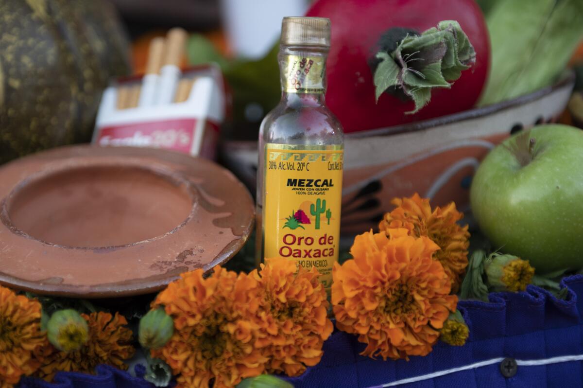 A bottle of mezcal on an ofrenda