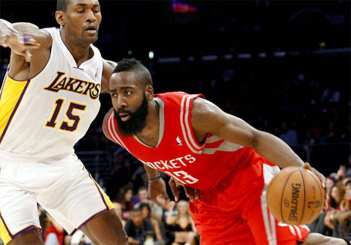 James Harden attempts to drive around Metta World Peace.