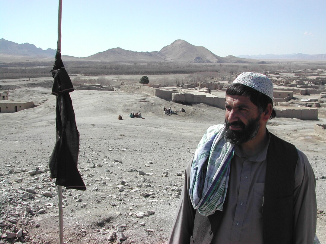 Dr. Syed Mir Ahmad Shah stands at the edge of the crater.