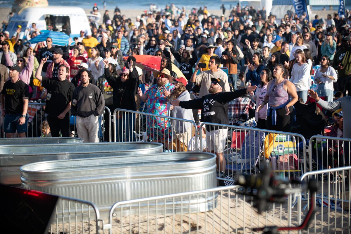 Tubs used for baptisms sit in front of thousands taking part in Baptize California.