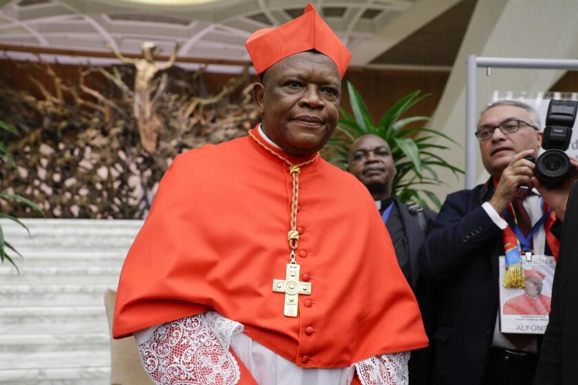 FILE - Cardinal Fridolin Among Besungu leaves after receiving the red three-cornered biretta hat from Pope Francis during a consistory inside St. Peter's Basilica, at the Vatican, Oct. 5, 2019. In the greatest rebuke of Pope Francis yet, the Catholic hierarchy of Africa and Madagascar issued a unified statement Thursday, Jan. 11, 2024, refusing to offer blessings to same-sex couples and reaffirming that such unions are “contrary to the will of God.” The statement, signed by Congolese Cardinal Fridolin Ambongo on behalf of the symposium of African national bishops conferences, marked the closest thing to a continent-wide dissent from a declaration Francis approved Dec. 18 allowing priests to offer such blessings. (AP Photo/Andrew Medichini)