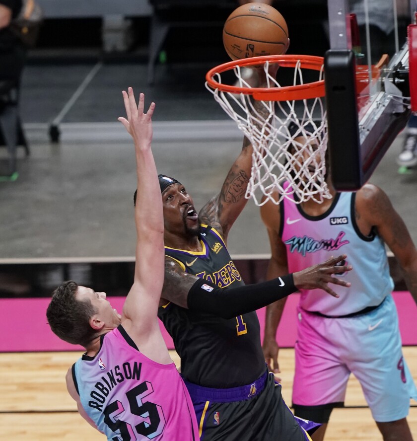 Lakers guard Kentavious Caldwell-Pope drives to the basket against Heat guard Duncan Robinson on Thursday in Miami.