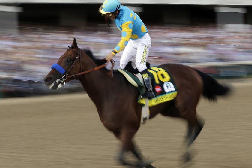 Victor Espinoza rides American Pharoah to victory in the 141st running of the Kentucky Derby horse race at Churchill Downs.