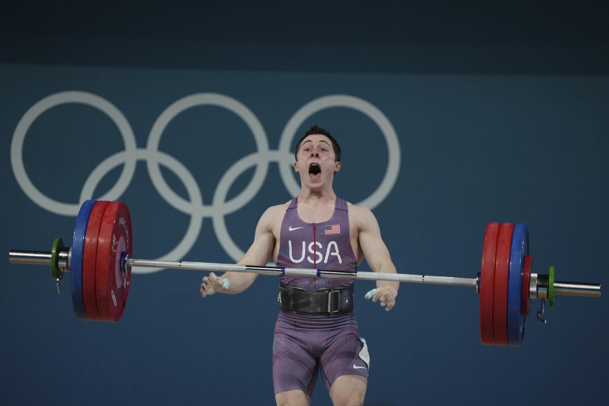 American Hampton Morris looks surprised as he competes during the men's 61kg weightlifting competition 