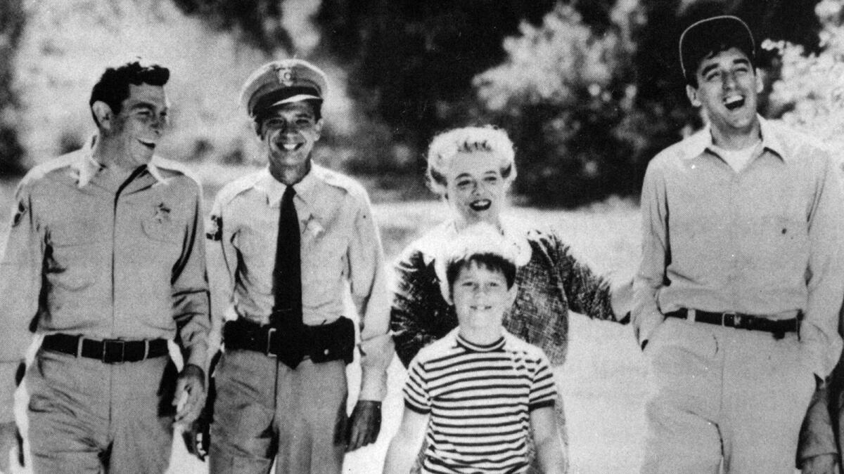 LAT FILE PHOTO ññ Andy Griffith, left, and friends in stable, orderly Mayberry, where everyone has a smile.