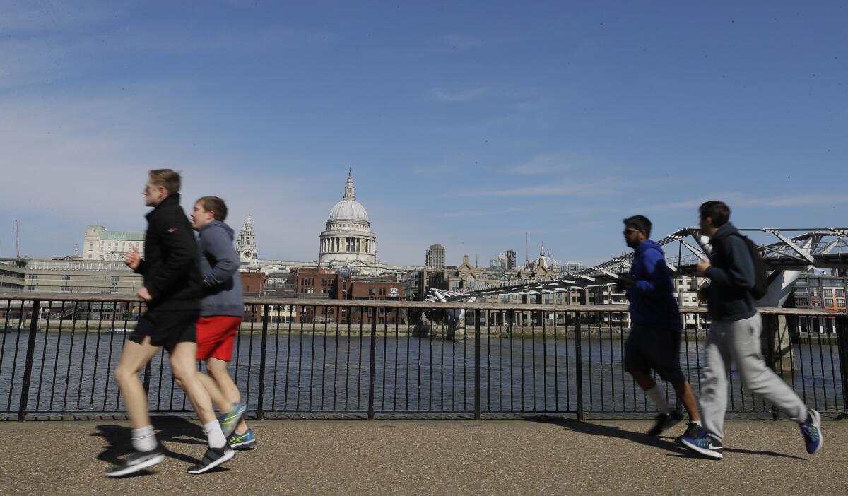 People running along the River Thames in London