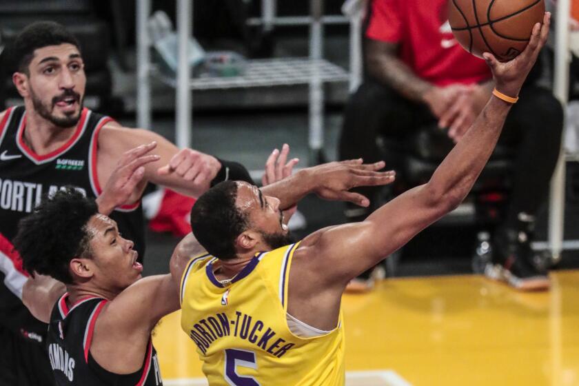 Los Angeles, CA, Monday, December 28, 2020 - Los Angeles Lakers guard Talen Horton-Tucker (5) slices past Portland Trail Blazers guard Anfernee Simons (1) for a first half layup at Staples Center. (Robert Gauthier/ Los Angeles Times)