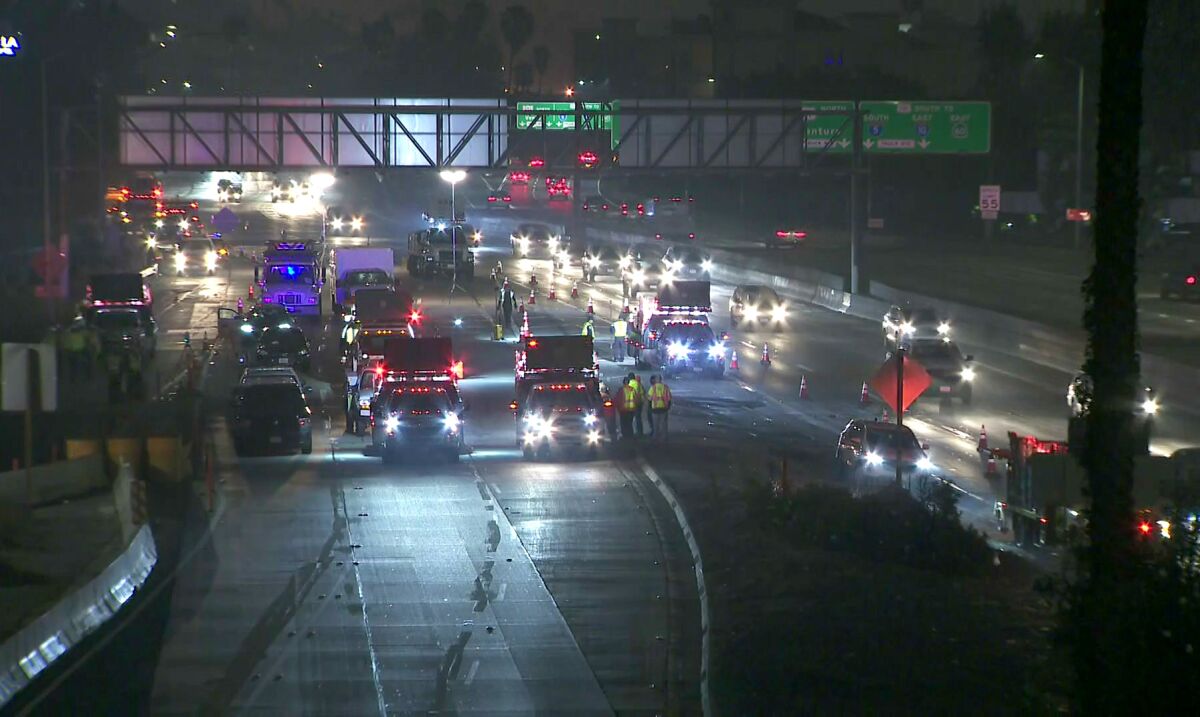 Traffic is stopped on the 110 Freeway after a Caltrans contract worker was struck and killed by a vehicle Wednesday. 