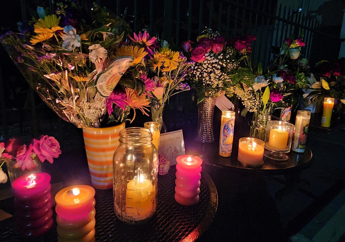A makeshift memorial of flowers and candles is seen Tuesday near the site where the body of Tatum Goodwin was found.