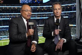 NBC Sports play-by-play announcer Mike Tirico, left, sits next to color commentator Cris Collinsworth 