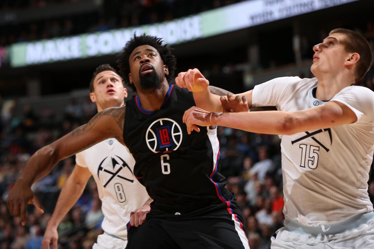Clippers center DeAndre Jordan (6) battles for position with Nuggets forward Nikola Jokic during a game in Denver on Tuesday night.
