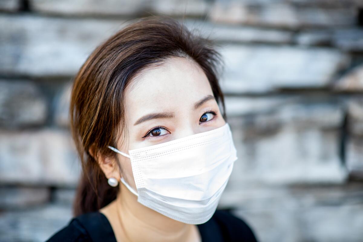closeup shot of a woman wearing a surgical mask