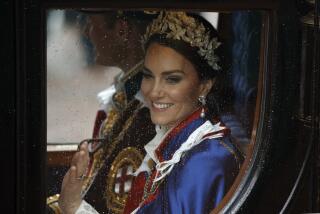 Princess Catherine waves from a royal carriage